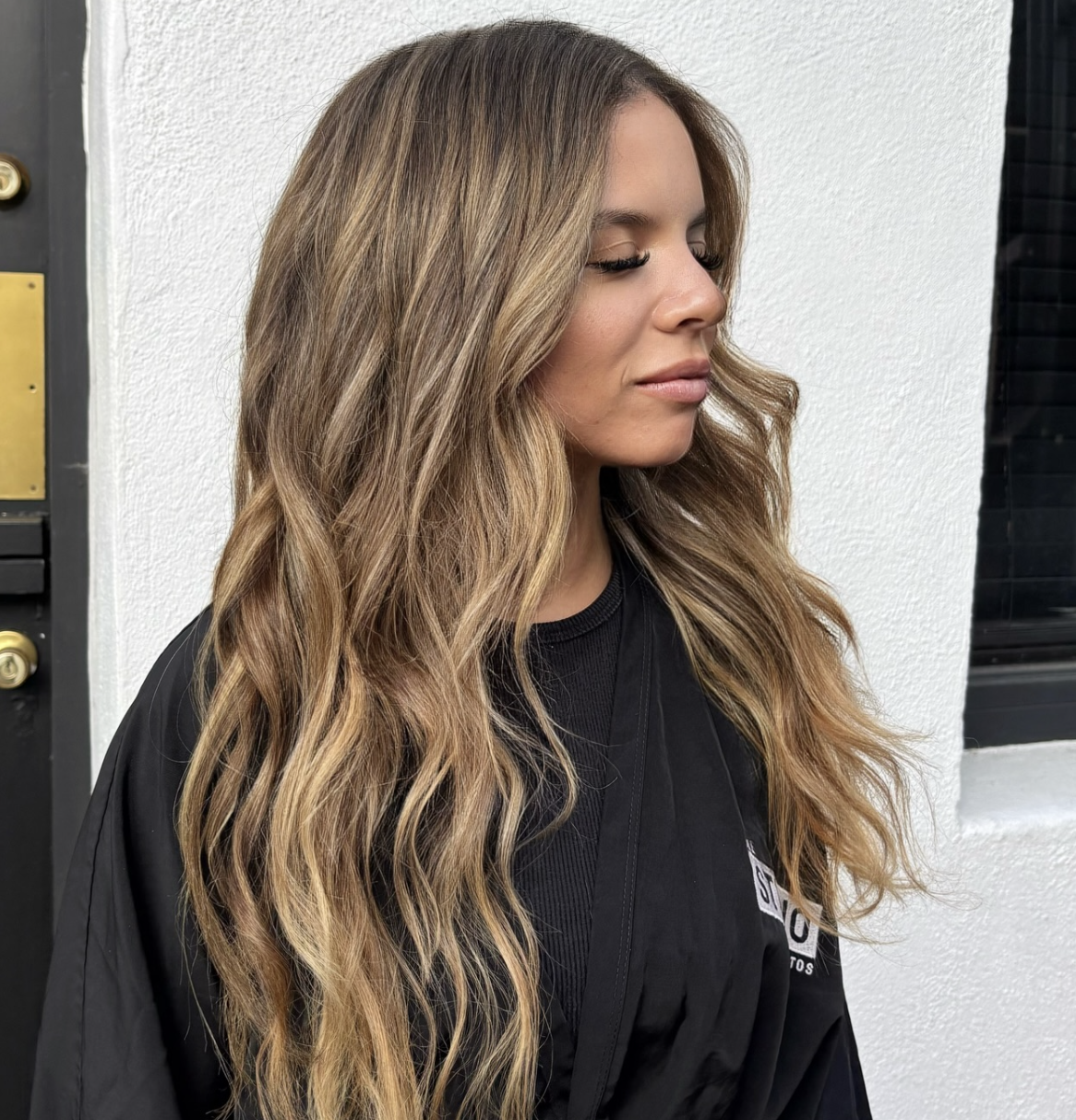 Side view of long golden balayage waves